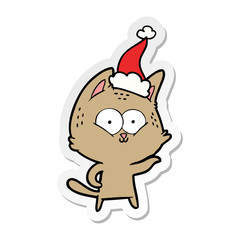 sticker cartoon of a cat wearing santa hat