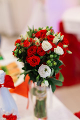 Wedding fresh bouquet stands in a vase.