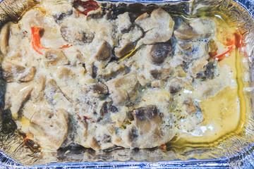 Baked meat with mushrooms in foil in the hot oven