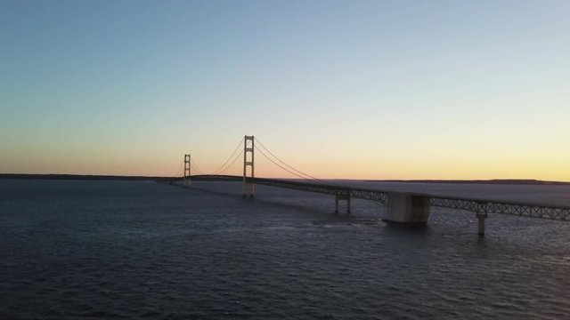 Wide aerial, bridge over the Great Lakes in Michigan at sunset