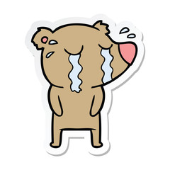 sticker of a cartoon crying bear