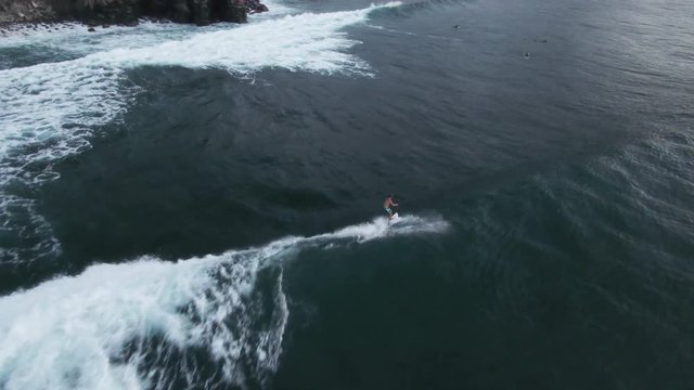 Surfer rides wave in Honokahua Bay, Hawaii, aerial