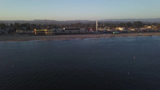 Wide aerial, buildings along beach in Santa Cruz, California