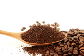 dark roasted coffee beans and ground coffee powder closeup on white background 