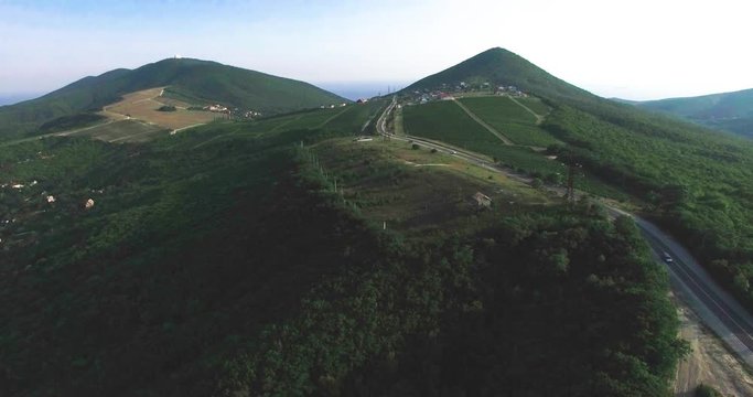 Aerial view of village houses and hills