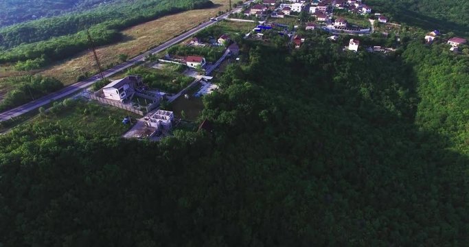 Aerial view of village houses and hills