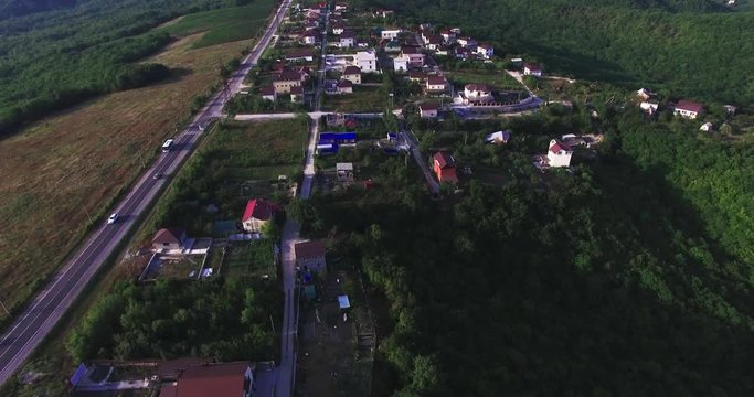 Aerial view of village houses and hills