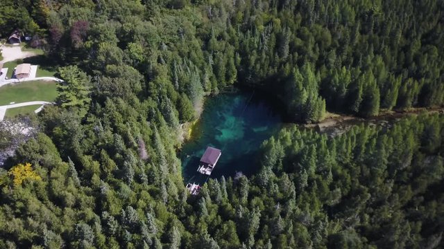 Aerial, raft moves over Kitch Iti Kipi spring at Michigan state park