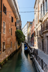 Italy, Venice, a narrow city street with old buildings in the background