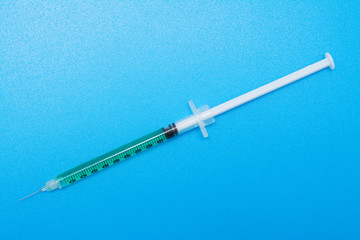 Insulin syringe isolated on blue