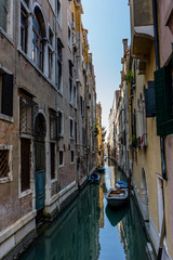 Obraz na płótnie Canvas Italy, Venice, BOATS MOORED ON CANAL AMIDST BUILDINGS IN CITY
