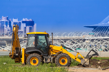 Excavator loader at a construction site. Excavator digs the ground with a bucket. Excavation. Digging the foundation pit. Construction machinery. Work equipment.