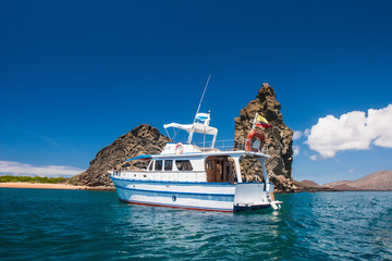 Galapagos. Ecuador. Yacht on the water near the rocks. Yachting. Boat trip on the Galapagos...