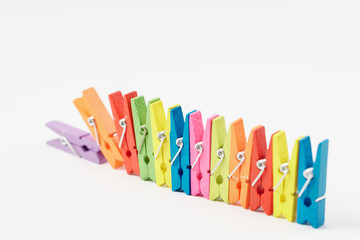 Colorful wooden clothespins on white background