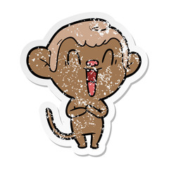 distressed sticker of a cartoon laughing monkey