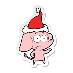sticker cartoon of a unsure elephant wearing santa hat