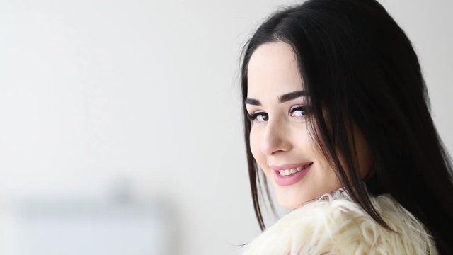 Close up portrait of woman turn around with windy hair long eyelashes happy smiling