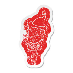 happy cartoon distressed sticker of a girl in space suit wearing santa hat