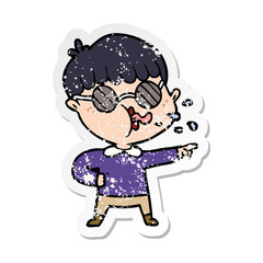 distressed sticker of a cartoon boy wearing spectacles and pointing