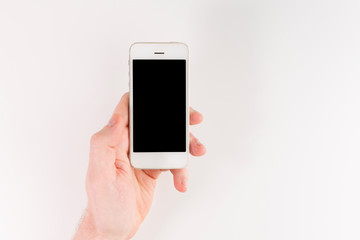 Fototapeta na wymiar Man hand holding white smartphone, isolated on white background
