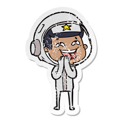 distressed sticker of a cartoon laughing astronaut