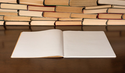 Blank notepad on the table with books background