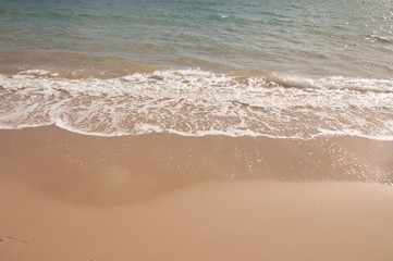 Fototapeta na wymiar Waves on the summer beach.