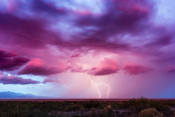 Lightning bolt with dramatic storm clouds at sunset