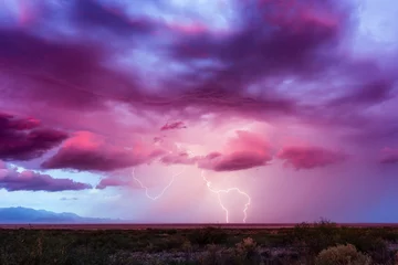 Fototapete Lightning bolt with dramatic storm clouds at sunset © JSirlin