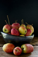 still life of apples in black clay bowl