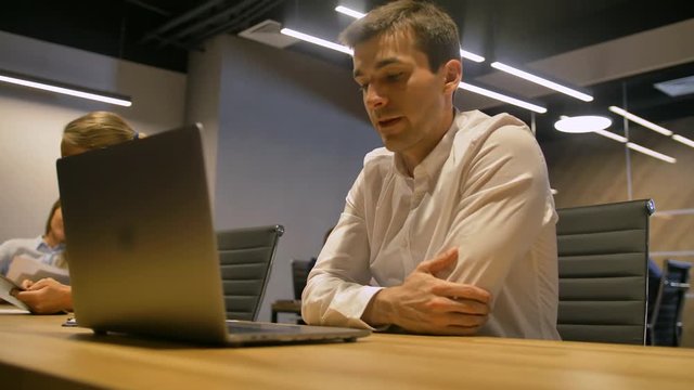 young businessman working on modern loft office at night.