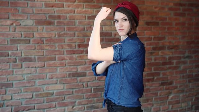 strong women rolling up sleeves - we can do it- historic feminist symbol