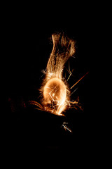 сlose-up of fire flame with sparks from the gas pocket lighter in different shapes isolated on a...