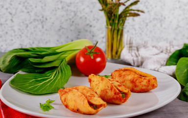 Big pasta shells staffed with meat, cheese and tomato sauce
