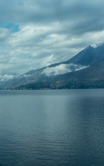 Italy, Varenna, Lake Como, a large body of water with a mountain in the background