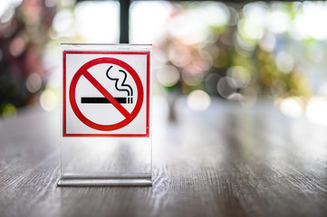 No smoking sign on wooden table in coffee shop Don't smoking place in public