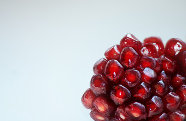 pomegranate berries in the corner photo on a light background macro.