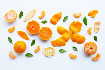 Orange fruits and green leaves on a white background.