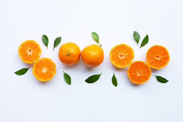 Orange fruits and green leaves on a white background.