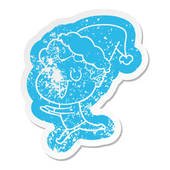 laughing cartoon distressed sticker of a man running wearing santa hat