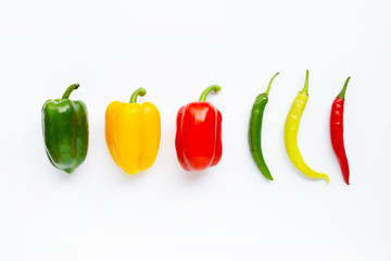Fototapeta na wymiar Different colors bell peppers and chili peppers isolated on white