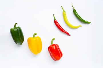 Different colors bell pepper and chili peppers isolated on white