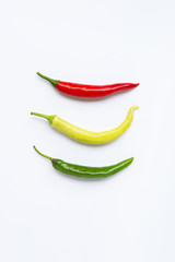 Different colors chili peppers isolated on white.