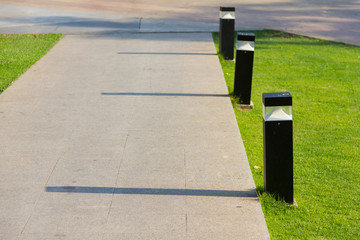 people walk on footpath with electricity post