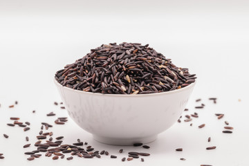 Rice berry in the white bowl in isolate white background.