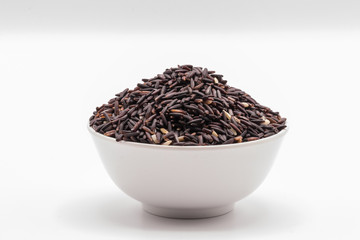 Rice berry in the white bowl in isolate white background.