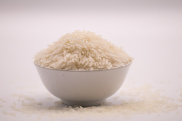 Jasmine rice in the white bowl in isolate white background.