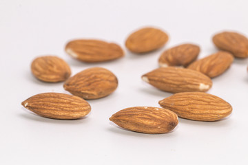 Raw natural organic close up Almonds on isolate white background.Close up Almond seeds.