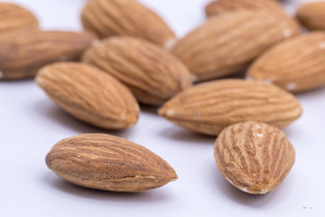 Raw natural organic close up Almonds on isolate white background.Close up Almond seeds.