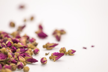Dried rose petal flower on isolate white background.Blurred close up flower buds and tea on white background.